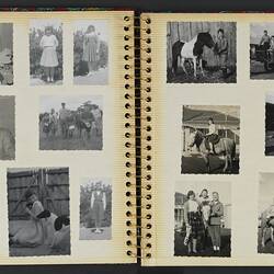 Open photo album with off white pages with fourteen black and white photographs.