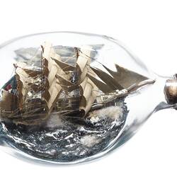 Model sailing ship in glass bottle.