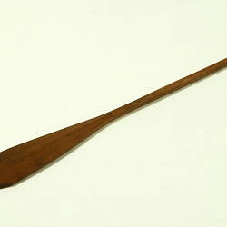 Wooden rod with flat end.