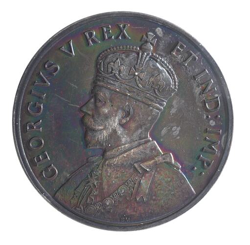 Round silver medal with bust of King facing left, wearing crown and formal attire. Text around.