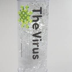 Clear cylinder with clear puzzle pieces inside.