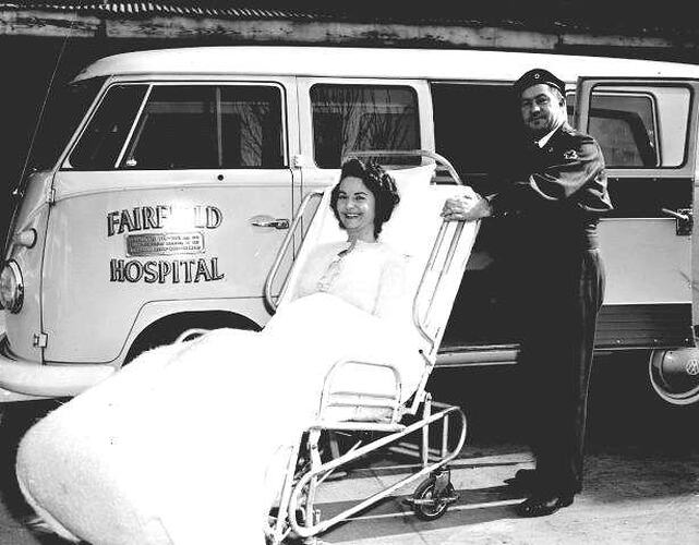 Negative - Red Cross Medical Officer & Female Patient on Trolley with Volkwagen 'Kombi' Van Ambulance, Fairfield Hospital, Victoria, 1962