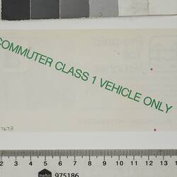 Back of rectangular white paper voucher with green printing.