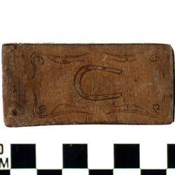 Wooden matchbox holder with horseshoe design.