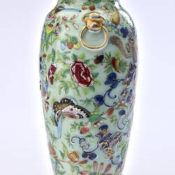 Porcelain vase with all-over pattern of birds, flowers, butterflies and two rats climbing amongst branches.