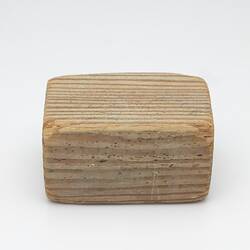 Block of pale-coloured wood.