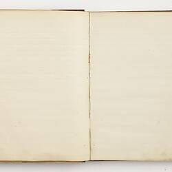 Open book with off white ruled pages.