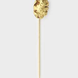 Stick pin with small gold nugget at top.