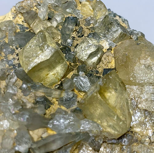 Llight green, square crystals embeded in rock.