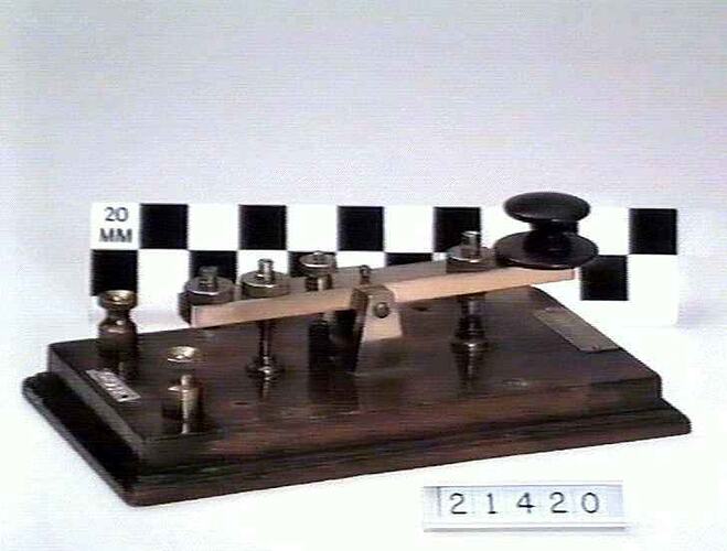 Machine for morse code, metal on a wooden board.