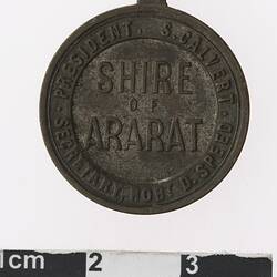 Round medal with text.