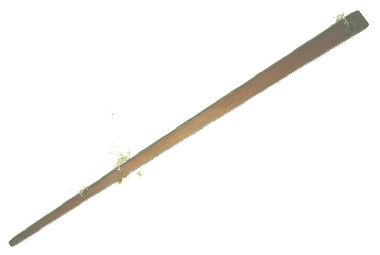 Long thin wooden foot pedal for floor loom. String attached in three places.