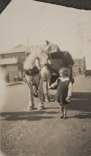 Digital Photograph - Girl Patting Council Worker's Cart Horse, St Kilda, circa 1930