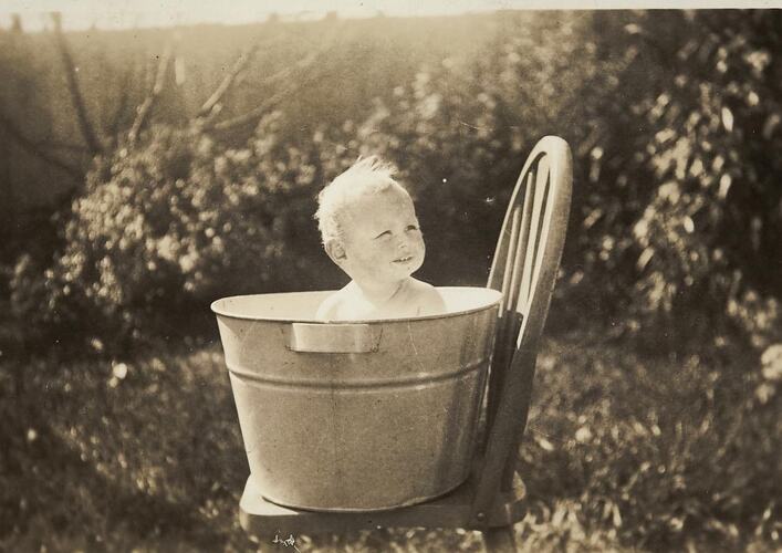 Digital Photograph - Baby in Tin Bath on Chair in Backyard, Alphington, 1934