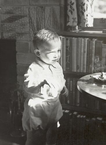 Digital Photograph - Boy by Small Table with Ashtray & Cigarettes on it, Lounge room, Nunawading, 1950