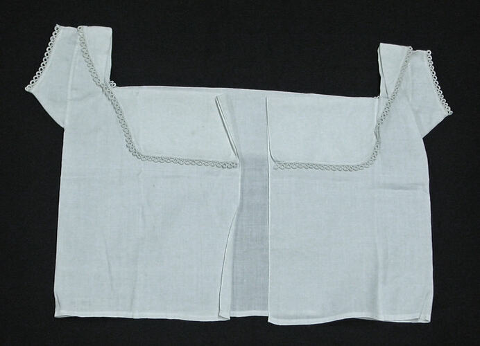 Front view of white chemise, lying flat.