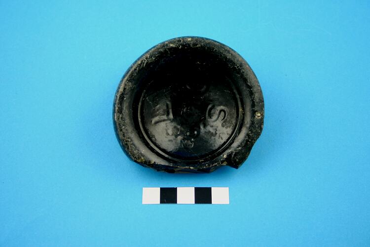 Broken base of a glass bottle.