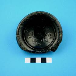 Broken base of a glass bottle.