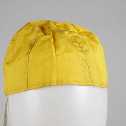 Yellow silk hat, conical to follow shape of head.
