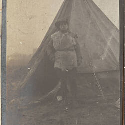 Soldier wearing slouch hat standing in front of tent.