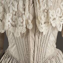 Detail, front view, faded grey silk wedding dress.