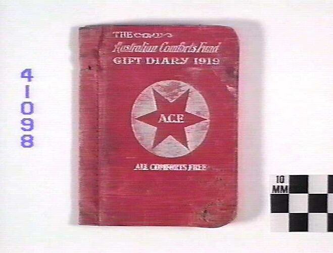 Book with red cover and white text, white circle with red six pointed star in centre.