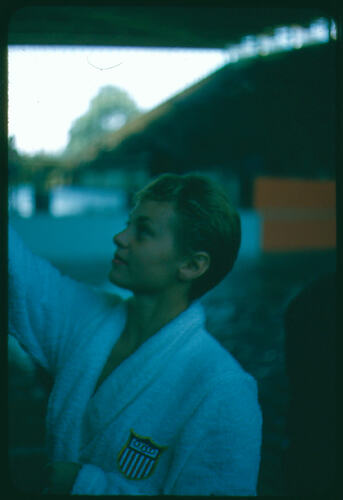 American female athlete wearing a towelling robe.