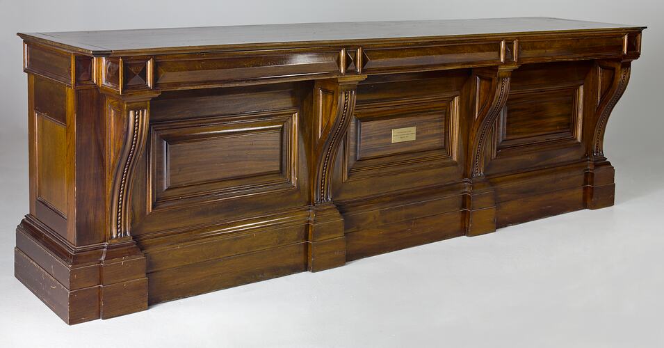 Decorative, carved wooden counter.