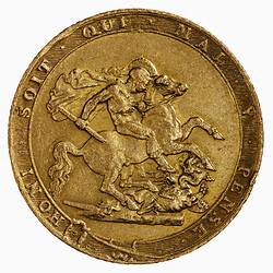 Round medal with figure on horse slaying dragon, text around.