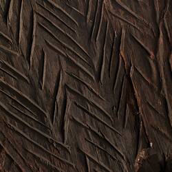 Wooden shield with detail of herringbone pattern.