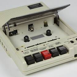 White cassette recorder with open cassette compartment.