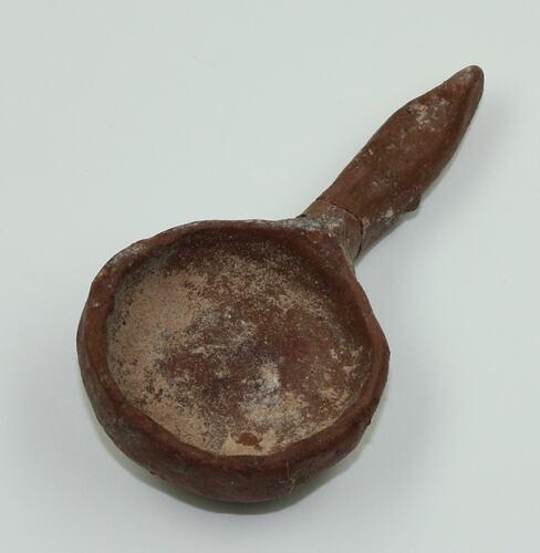 Clay toy spoon, viewed from above.