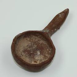 Clay toy spoon, viewed from above.
