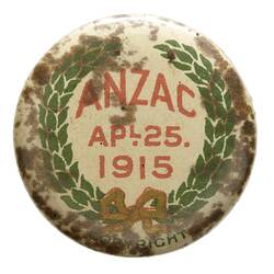 Badge with red text surrounded by wreath.