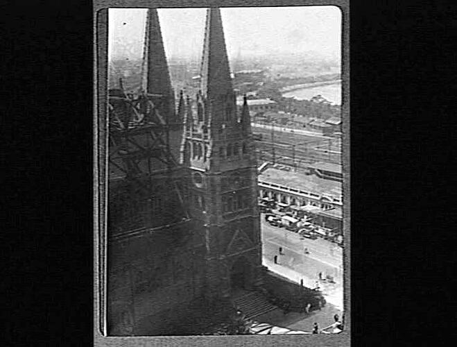 Elevated view of cathedral. Two spires are visible and train lines in background.