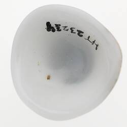 White cup shaped object - back of a prosthetic eye.