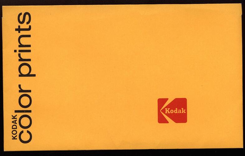Yellow paper envelope with black and red text.