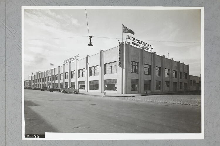 Monochrome photograph of a showroom exterior.