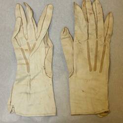 Pair of cream gloves, front side.