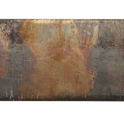 Plain back of a rectangular, bronze plaque.
