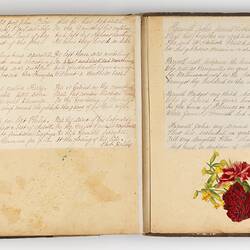 Open scrapbook showing 2 pages of inscriptions and illustration of floral motif.