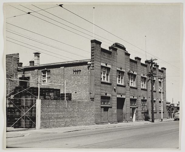 Street view of the exterior of a two storey brick building.