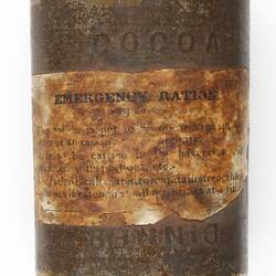 Rusted, metal tin with browned paper label.