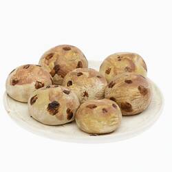 Model of seven miniature round buns with brown spots on a white plate.