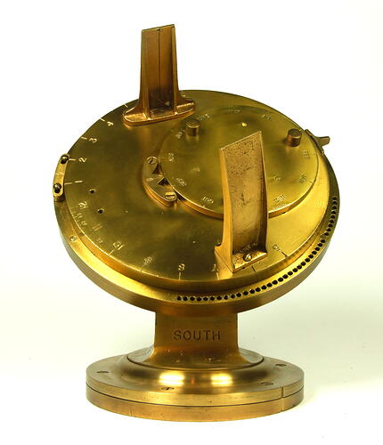 Front view of gold metal chronometer.