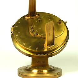 Front view of gold metal chronometer.