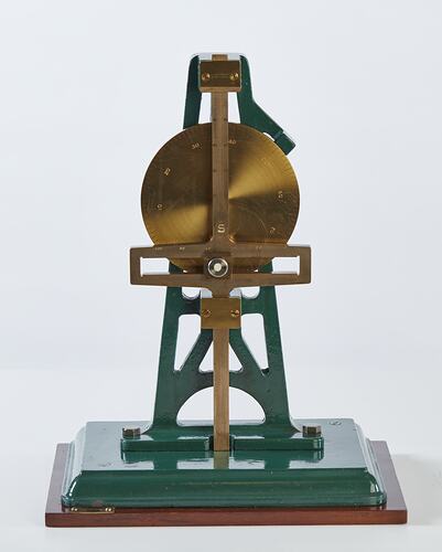 Metal model with green painted frame with metal circular shape and horizontal piece.
