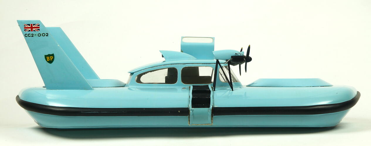 Light blue hovercraft with two propellers, facing right.