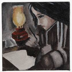 Female writing in book on table with lamp at her side.