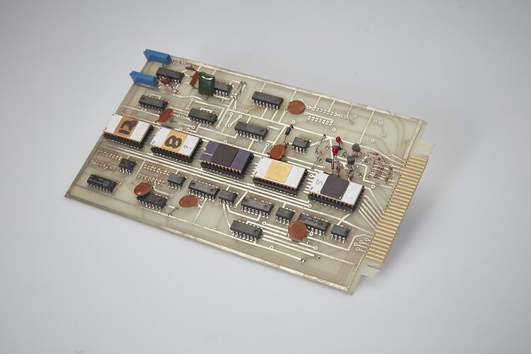 Rectangular grey plastic circuit board with electrical components soldered in place.